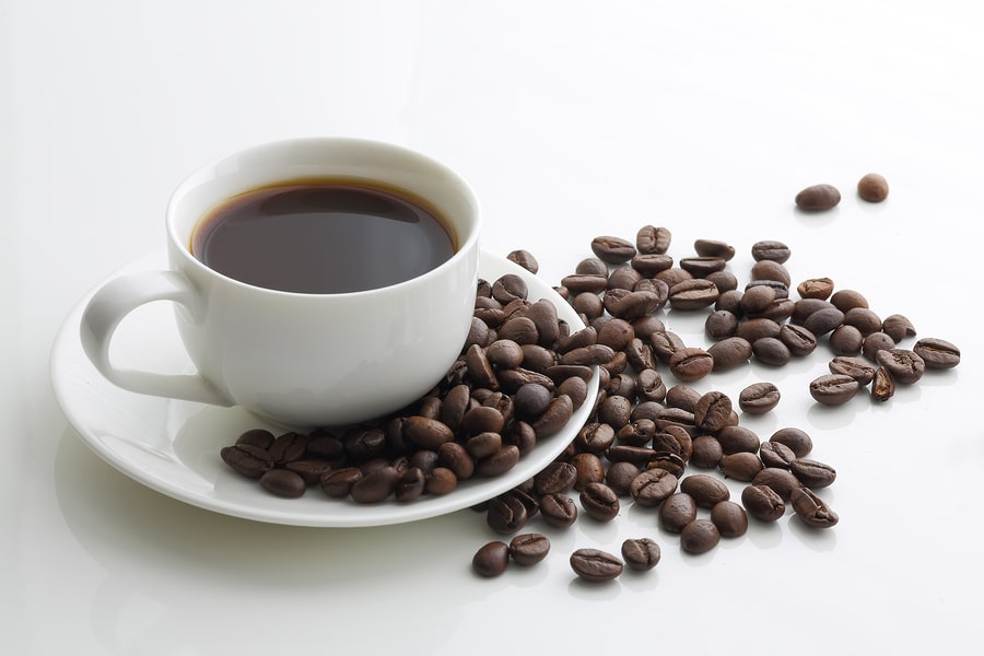 Cup Of Coffee And Coffee Beans On A White