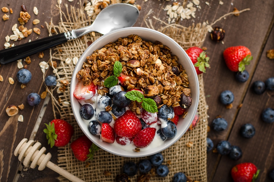 Yogurt With Baked Granola And Berries In Small Bowl